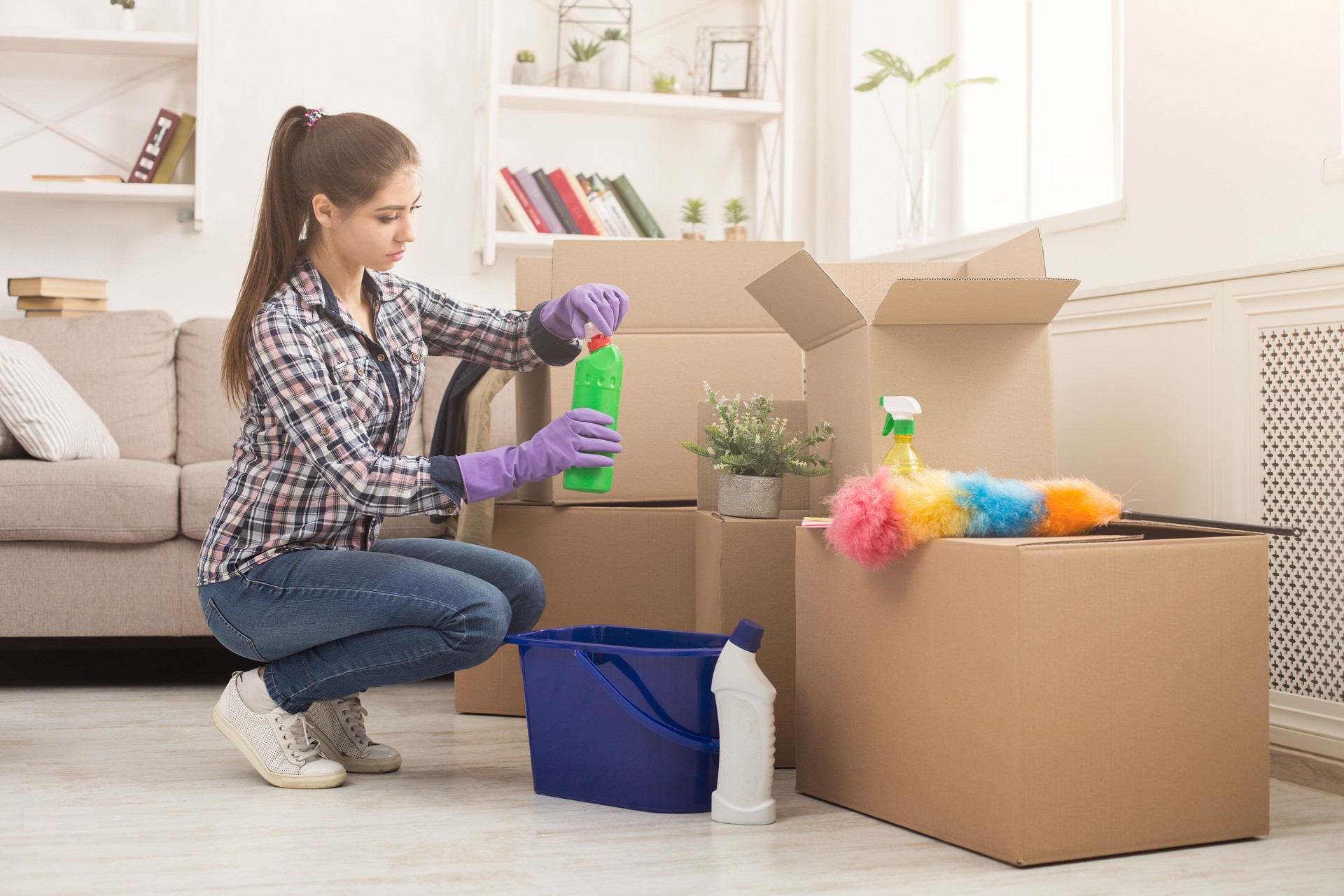 Young woman unpacking boxes after moving
